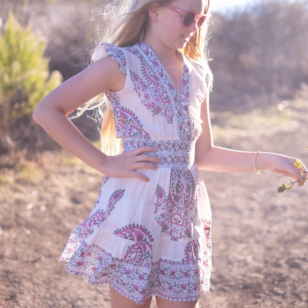 100% cotton ruffle sleeve mini dress with fitted waist & tassels at neckline